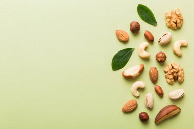 Composition of nuts , flat lay - mix hazelnuts, cashews, almonds on table background. healthy eating concepts and food background.