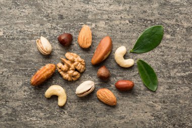 Composition of nuts , flat lay - mix hazelnuts, cashews, almonds on table background. healthy eating concepts and food background.