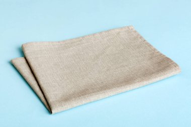 top view with gray kitchen napkin isolated on table background. Folded cloth for mockup with copy space, Flat lay. Minimal style.