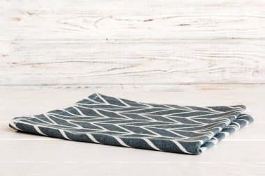 top view with blue kitchen napkin isolated on table background. Folded cloth for mockup with copy space, Flat lay. Minimal style.