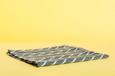 top view with blue kitchen napkin isolated on table background. Folded cloth for mockup with copy space, Flat lay. Minimal style.