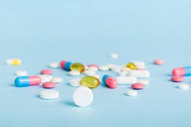 Many different colorful medication and pills perspective view. Set of many pills on colored background.