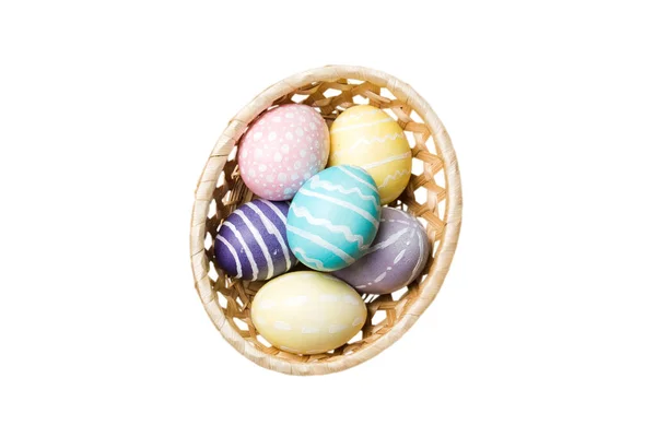 stock image Basket of colorful Easter eggs isolated on white background. Easter basket filled with colored eggs top view holiday concept .