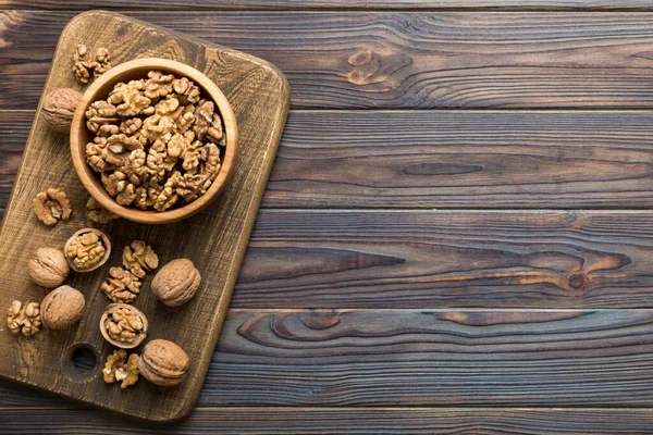 stock image Fresh healthy walnuts in bowl on colored table background. Top view Healthy eating bertholletia concept. Super foods.