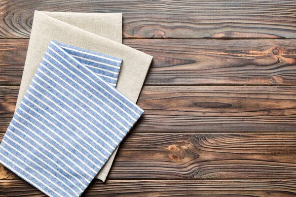 stock image top view with blue kitchen napkin isolated on table background. Folded cloth for mockup with copy space, Flat lay. Minimal style.