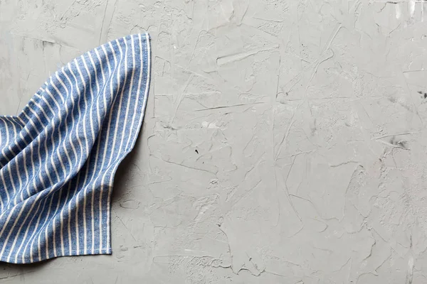 stock image top view with blue kitchen napkin isolated on table background. Folded cloth for mockup with copy space, Flat lay. Minimal style.