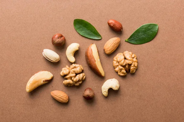 Composition of nuts , flat lay - mix hazelnuts, cashews, almonds on table background. healthy eating concepts and food background.