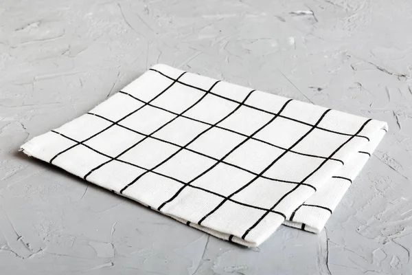 top view with white empty kitchen napkin isolated on table background. Folded cloth for mockup with copy space, Flat lay. Minimal style.