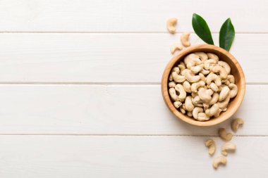 cashew nuts in wooden bowl on table background. top view. Space for text. Healthy food