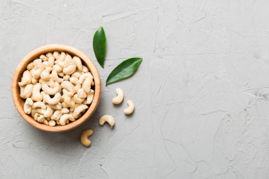 cashew nuts in wooden bowl on table background. top view. Space for text. Healthy food