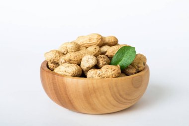 Fresh healthy peanuts in bowl on colored table background. Top view Healthy eating bertholletia concept. Super foods.