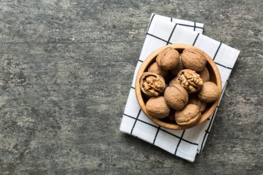 Fresh healthy walnuts in bowl on colored table background. Top view Healthy eating bertholletia concept. Super foods.