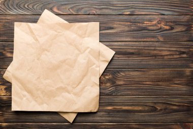 top view with baking parchment empty on table background. Folded cloth for mockup with copy space, Flat lay. Minimal style.