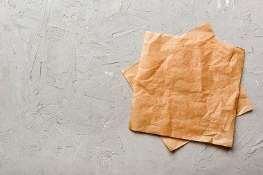 top view with baking parchment empty on table background. Folded cloth for mockup with copy space, Flat lay. Minimal style.