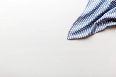 top view with blue kitchen napkin isolated on table background. Folded cloth for mockup with copy space, Flat lay. Minimal style.