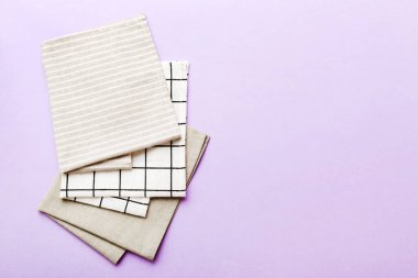 top view with gray kitchen napkin isolated on table background. Folded cloth for mockup with copy space, Flat lay. Minimal style.