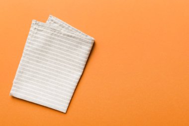top view with gray kitchen napkin isolated on table background. Folded cloth for mockup with copy space, Flat lay. Minimal style.