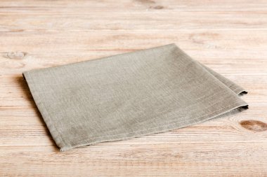 top view with gray kitchen napkin isolated on table background. Folded cloth for mockup with copy space, Flat lay. Minimal style.