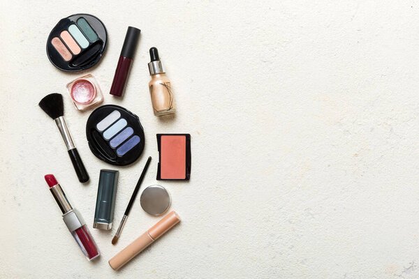 Professional makeup tools. Top view. Flat lay. Beauty, decorative cosmetics. Makeup brushes set and color eyeshadow palette on table background. Minimalistic style.