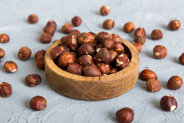 stock image Wooden bowl full of hazelnuts on table background. Healthy eating concept. Super foods.