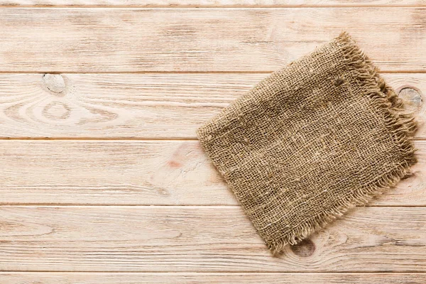 stock image Old burlap fabric napkin, sackcloth on table background. top view with copy space.