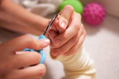 Bebek tırnaklarını kesmek. Bebek bakımı, yeni doğmuş tırnakların kapalı çekimi..