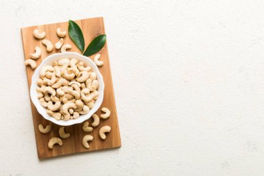 cashew nuts in wooden bowl on table background. top view. Space for text. Healthy food