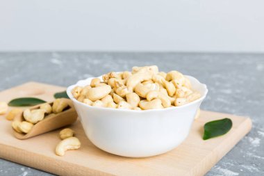 cashew nuts in wooden bowl on table background. top view. Space for text. Healthy food