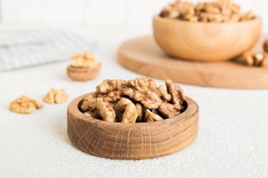 Fresh healthy walnuts in bowl on colored table background. Top view Healthy eating bertholletia concept. Super foods.
