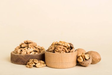 Fresh healthy walnuts in bowl on colored table background. Top view Healthy eating bertholletia concept. Super foods.