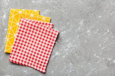 top view with red empty kitchen napkin isolated on table background. Folded cloth for mockup with copy space, Flat lay. Minimal style.