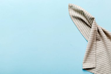 top view with gray kitchen napkin isolated on table background. Folded cloth for mockup with copy space, Flat lay. Minimal style.