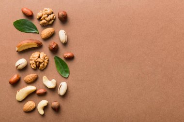 Composition of nuts , flat lay - mix hazelnuts, cashews, almonds on table background. healthy eating concepts and food background.