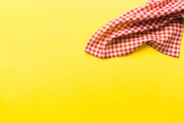 top view with red empty kitchen napkin isolated on table background. Folded cloth for mockup with copy space, Flat lay. Minimal style.