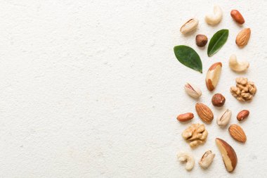 Composition of nuts , flat lay - mix hazelnuts, cashews, almonds on table background. healthy eating concepts and food background.