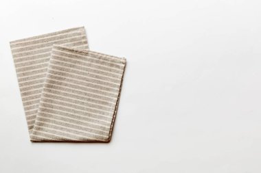top view with gray kitchen napkin isolated on table background. Folded cloth for mockup with copy space, Flat lay. Minimal style.