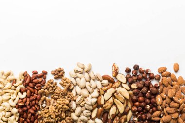 different nuts frame background. Close up, top view, flat lay with vopy space. Walnut, pistachios, almonds, hazelnuts and cashews.