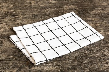 top view with white empty kitchen napkin isolated on table background. Folded cloth for mockup with copy space, Flat lay. Minimal style.