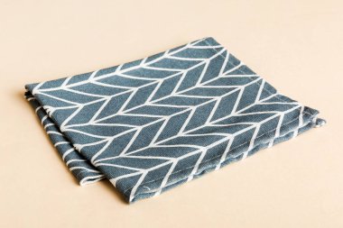 top view with blue kitchen napkin isolated on table background. Folded cloth for mockup with copy space, Flat lay. Minimal style.