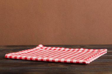 top view with red empty kitchen napkin isolated on table background. Folded cloth for mockup with copy space, Flat lay. Minimal style.