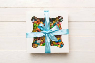 Box with sweet chocolate candies on color background, Various candy sweets. Valentines day gift box. Top view flat lay with copy space.