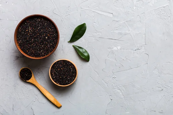 stock image quinoa seeds in bowl and spoon on colored background. Healthy kinwa in small bowl. Healthy superfood.