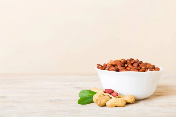 stock image Fresh healthy peanuts in bowl on colored table background. Top view Healthy eating bertholletia concept. Super foods.