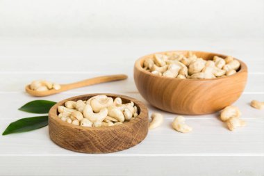 cashew nuts in wooden bowl on table background. top view. Space for text. Healthy food