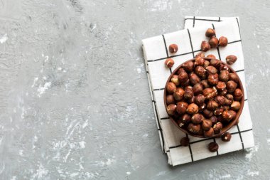 Wooden bowl full of hazelnuts on table background. Healthy eating concept. Super foods.