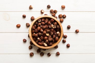 Wooden bowl full of hazelnuts on table background. Healthy eating concept. Super foods.
