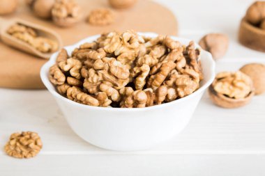 Fresh healthy walnuts in bowl on colored table background. Top view Healthy eating bertholletia concept. Super foods.