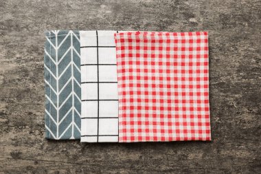 top view with red empty kitchen napkin isolated on table background. Folded cloth for mockup with copy space, Flat lay. Minimal style.