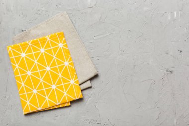 top view with yellow empty kitchen napkin isolated on table background. Folded cloth for mockup with copy space, Flat lay. Minimal style.