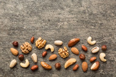 Composition of nuts , flat lay - mix hazelnuts, cashews, almonds on table background. healthy eating concepts and food background.